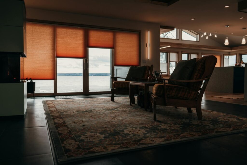 A cellular shade lowered over a living room window.