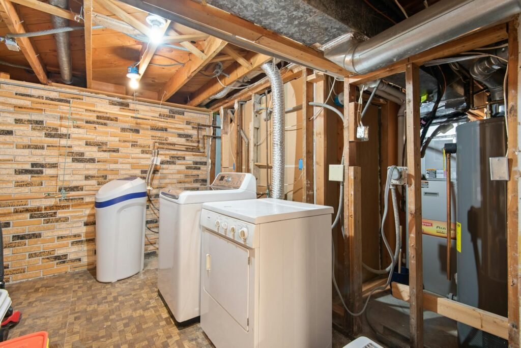 A tidy utility area with a water heater and laundry connections visible for inspection.