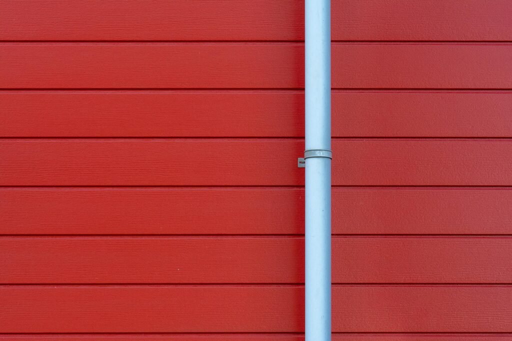 A roof-to-wall corner above siding and gutter where water problems often start