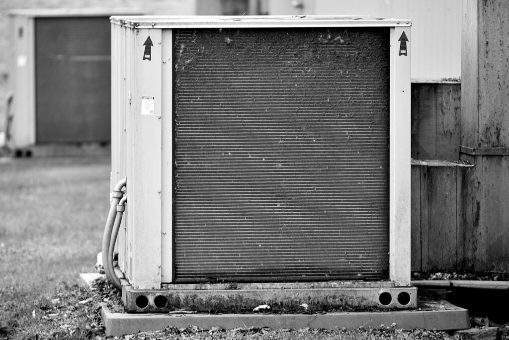 A new HVAC filter next to a return grille with the install date written on the frame.