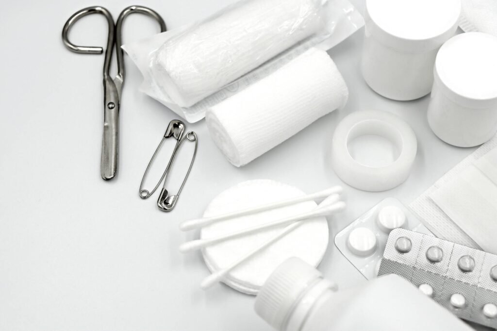 Bathroom caulking tools including sealant, scraper, tape, and cleaning supplies arranged neatly