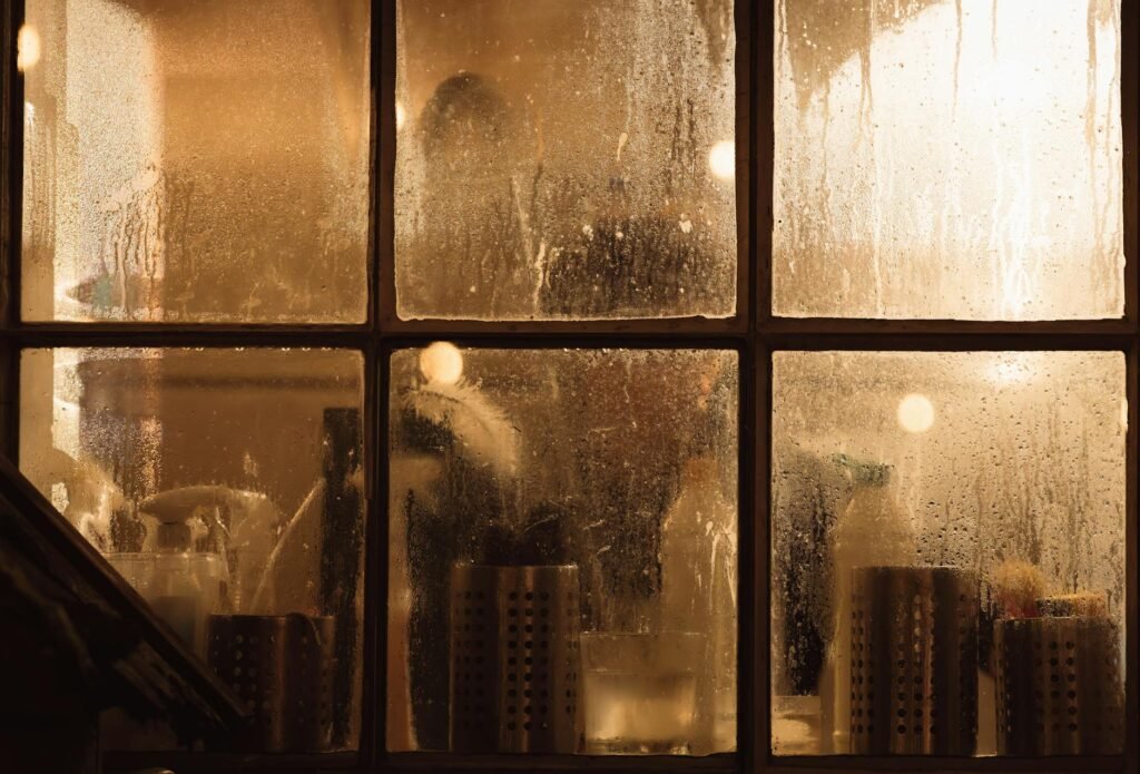 Condensation forming on the inside of an older window.