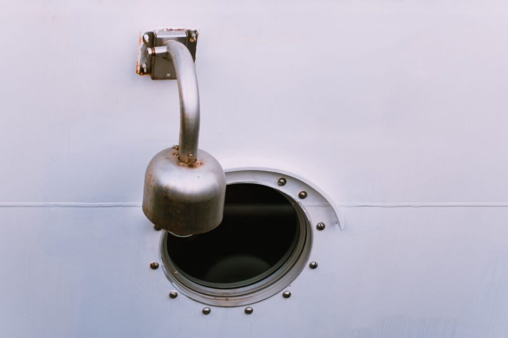 An exterior dryer vent hood on house siding with the flap visible.