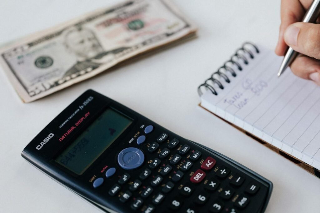 Household budgeting desk with repair estimate, calculator, and utility bills