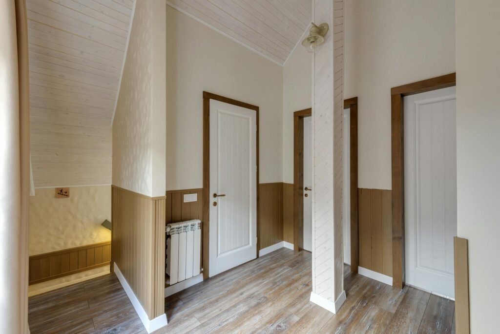 Hallway outside bedrooms with a ceiling alarm in view