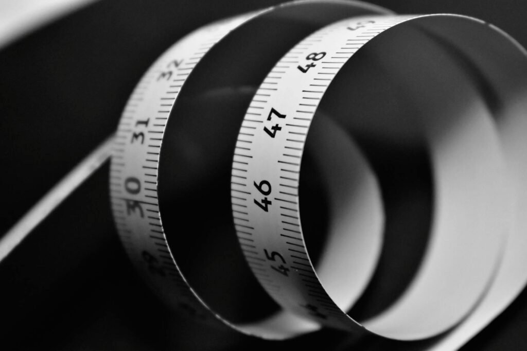 A ruler standing in attic insulation to show depth measurement.