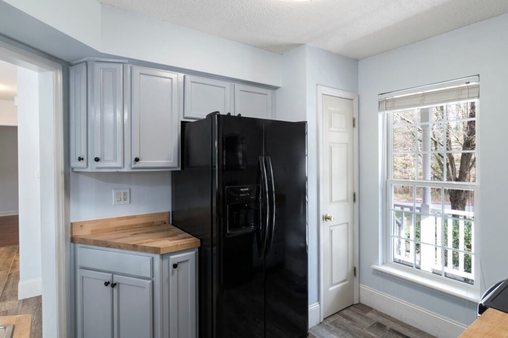 Refrigerator positioned with visible space behind it for airflow