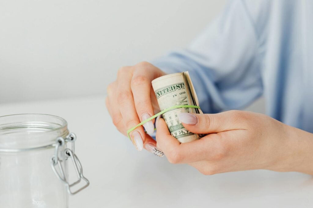 Hand checking the seal on an exterior door with a dollar bill